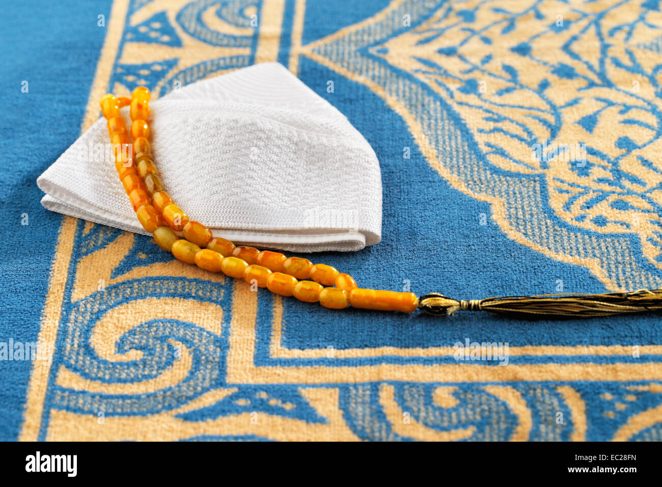 The Masbaha is also known as Tasbih is a string of prayer beads which is traditionally used by Muslims along with the Quran Stock Photo