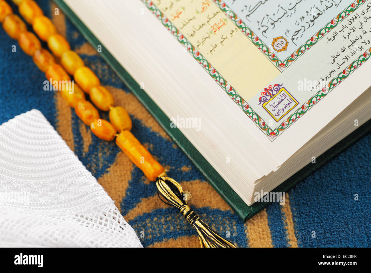 The Masbaha is also known as Tasbih is a string of prayer beads which is traditionally used by Muslims along with the Quran Stock Photo