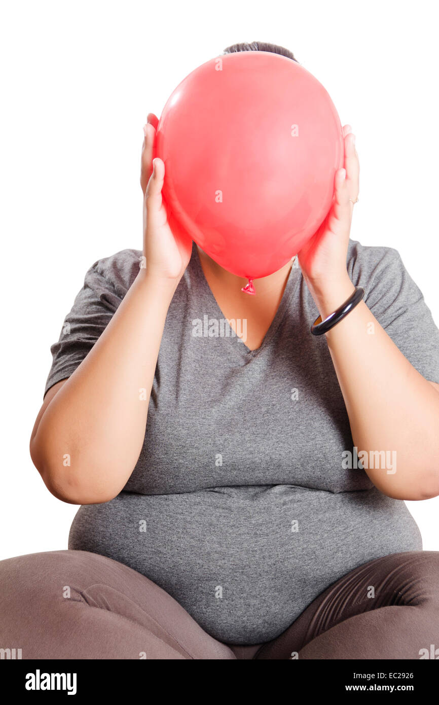 indian Obese  Lady Hiding Balloon Stock Photo