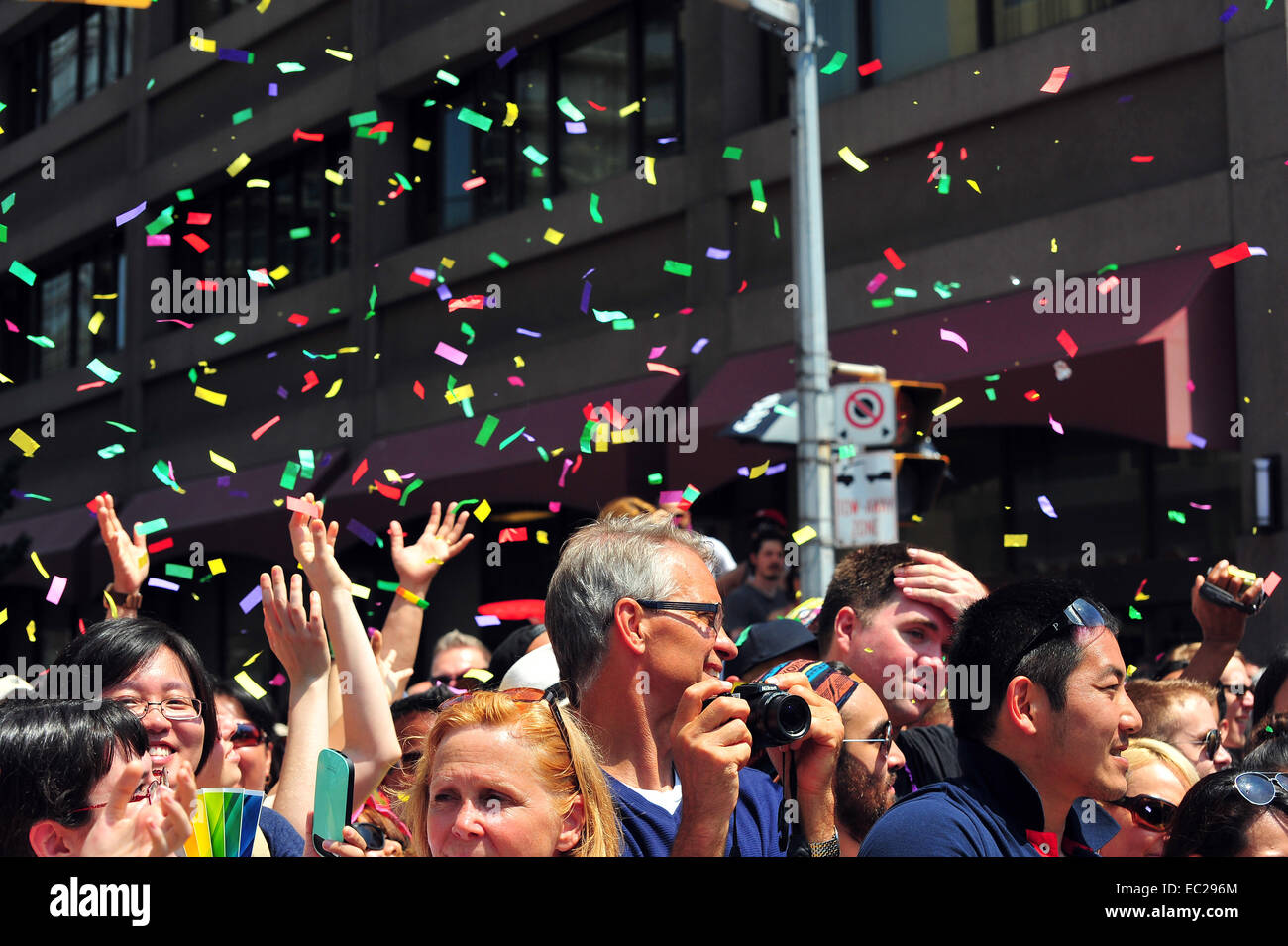 A crowd stands under falling confetti at the 2014 World Pride in Toronto. Stock Photo