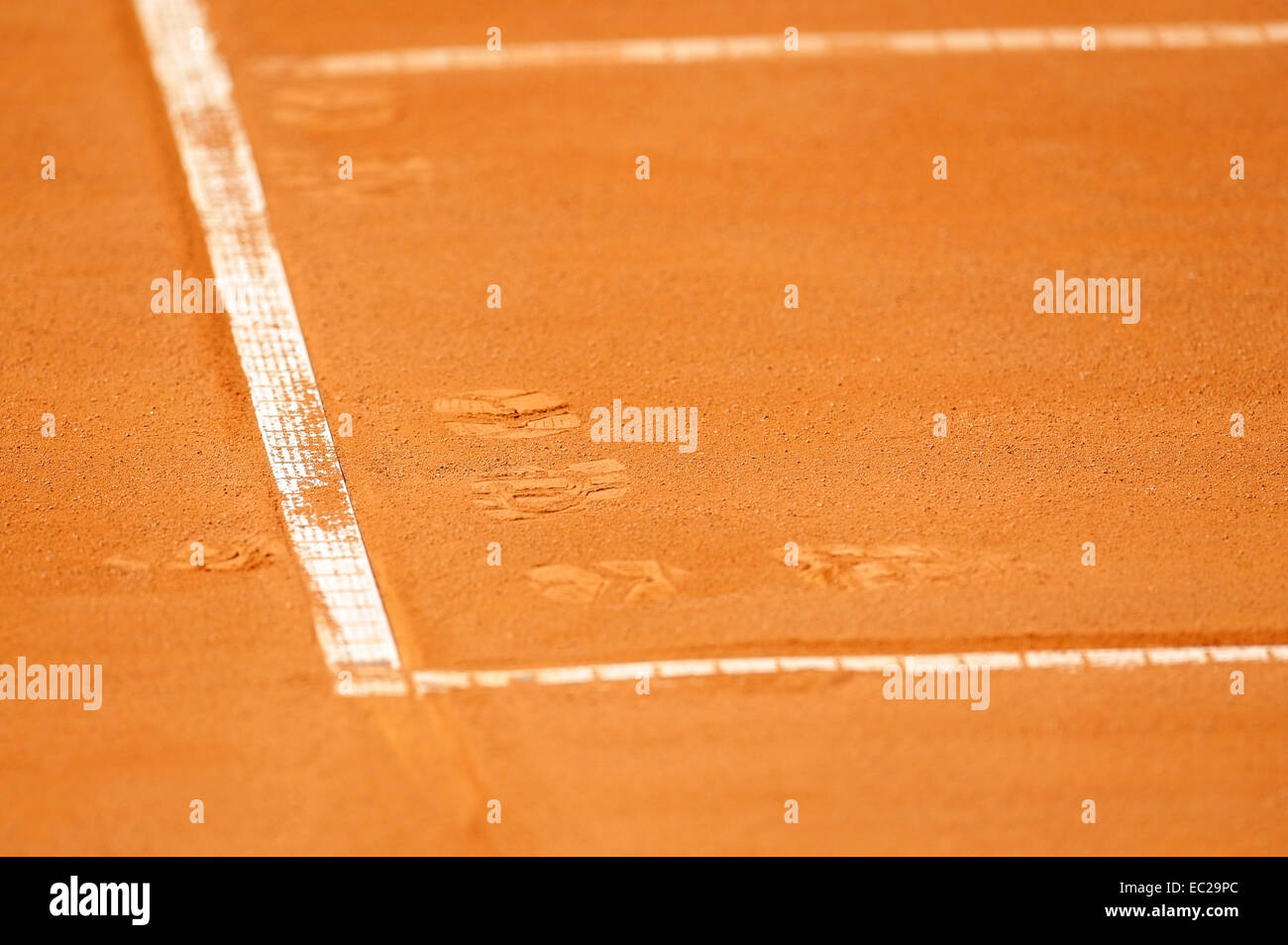 Detail with a baseline and footprints on a tennis clay court Stock