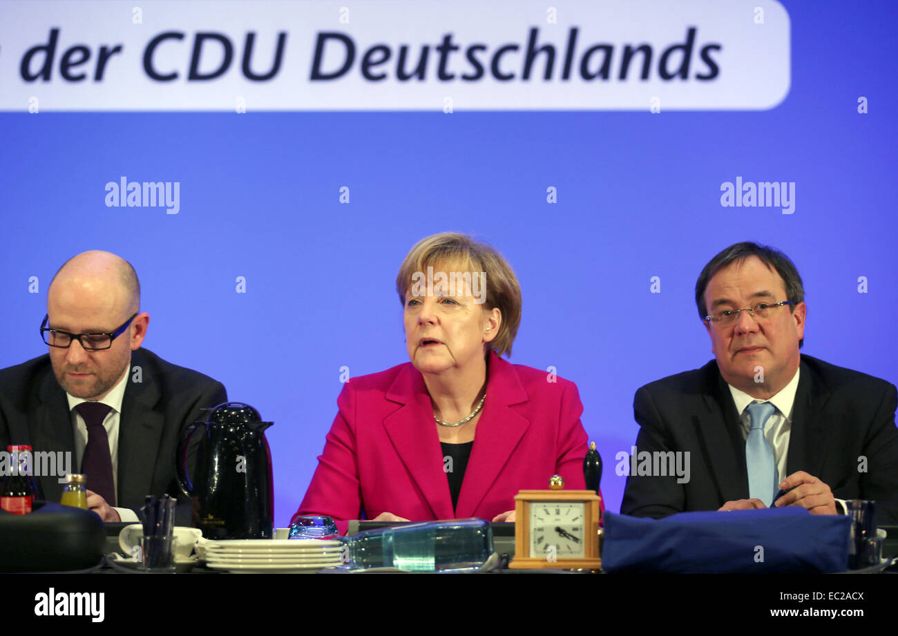 Cologne, Germany. 08th Dec, 2014. Chancellor Angela Merkel (C) opens the CDU federal party convention next to CDU state party leader of North Rhine-Westphalia Armin Laschet (R) and Secretary General of the Christian Democratic Union (CDU) Peter Tauber (L) in Cologne, Germany, 08 December 2014. The party convention takes place on Tuesday and Wednesday. Photo: OLIVER BERG/dpa/Alamy Live News Stock Photo