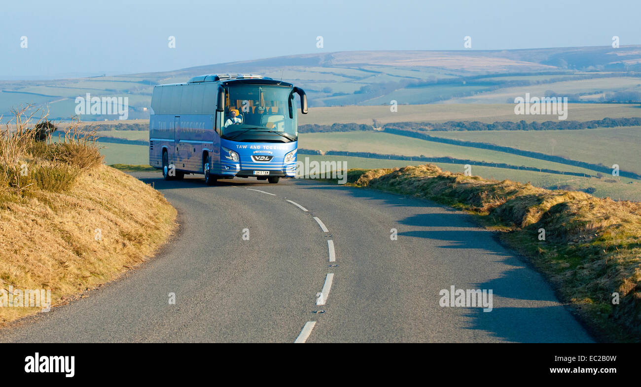 A holiday coach tour driving through Devon Stock Photo