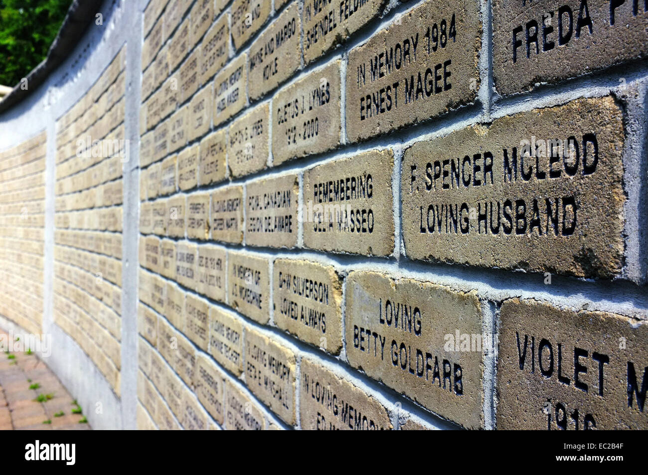 A wall of bricks with words carved on to them. Stock Photo