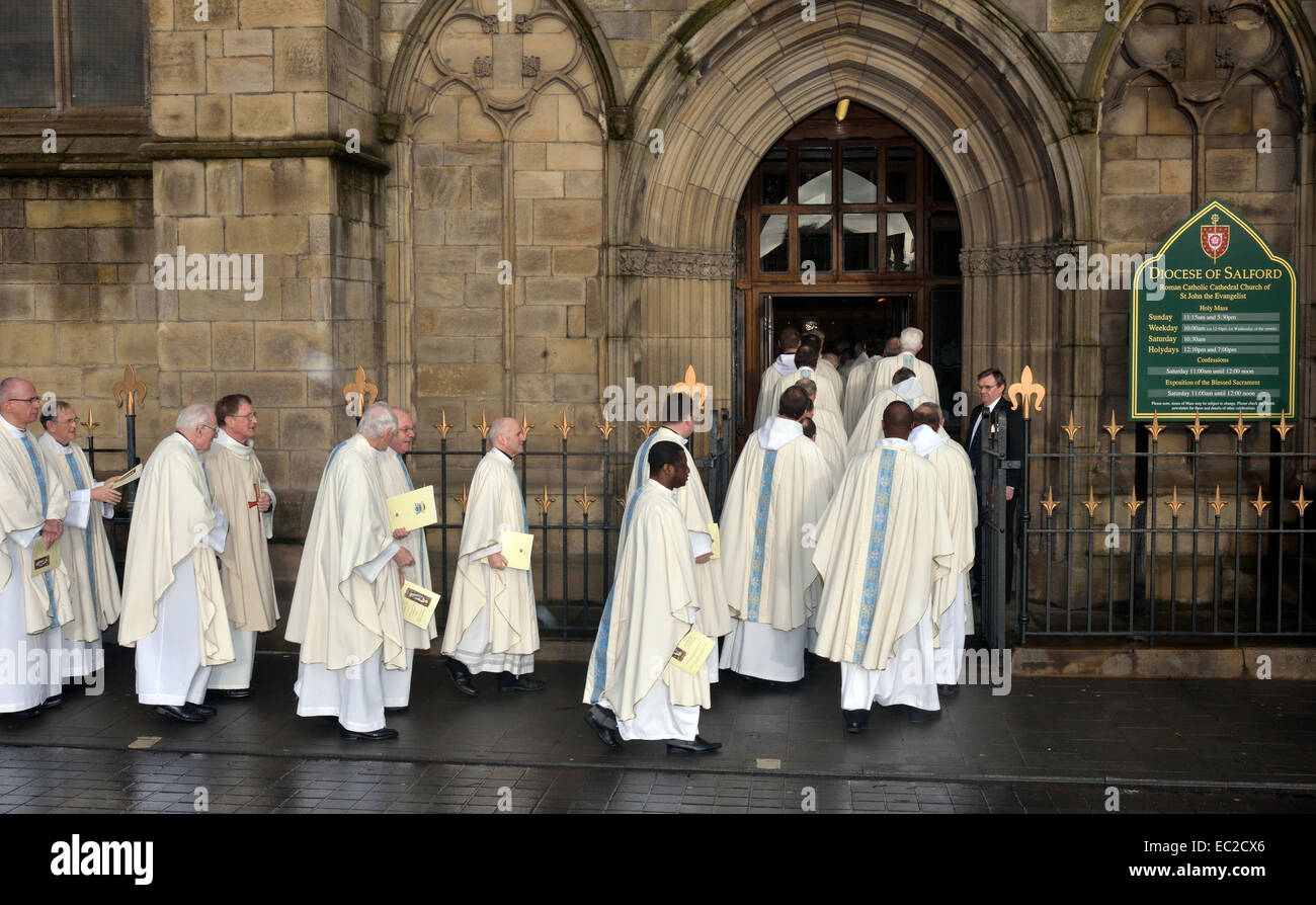 Salford, Greater Manchester, UK  8th December 2014 Priests from the Roman Catholic Diocese of Salford enter the Cathedral for the solemn mass of installation of the Right Reverend John Stanley Kenneth Arnold as the eleventh bishop of Salford. He replaces Bishop Terence Brain, who has retired after becoming the tenth bishop in 1997. Bishop Arnold was previously an auxiliary bishop in the Diocese of Westminster. New Roman Catholic  Bishop of Salford Credit:  John Fryer/Alamy Live News Stock Photo