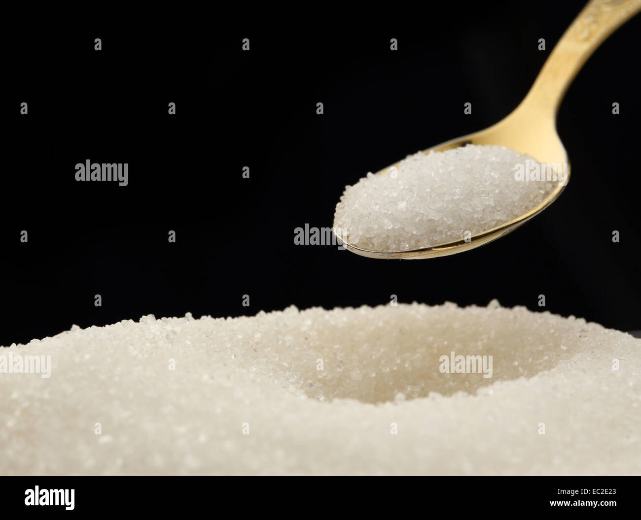 Heap of white sugar and spoon Stock Photo