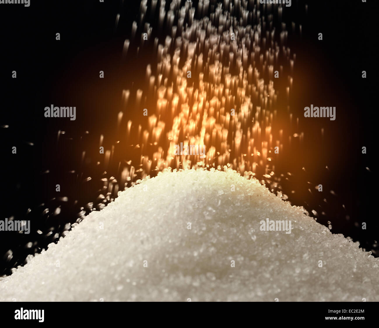 Flow of white sugar on black Stock Photo