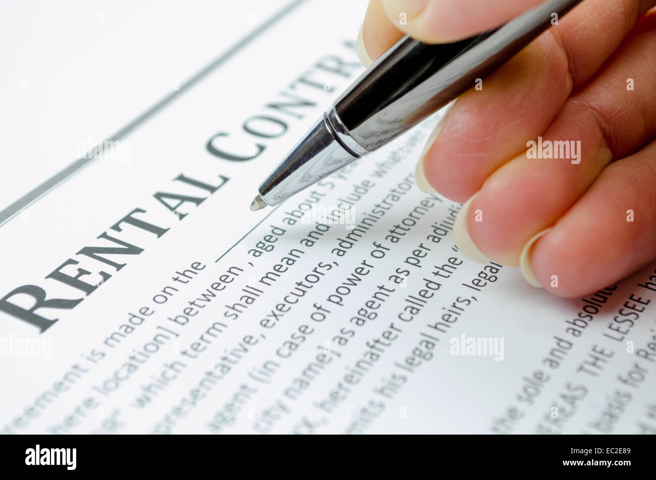 Female hand filling rental contract Stock Photo Alamy