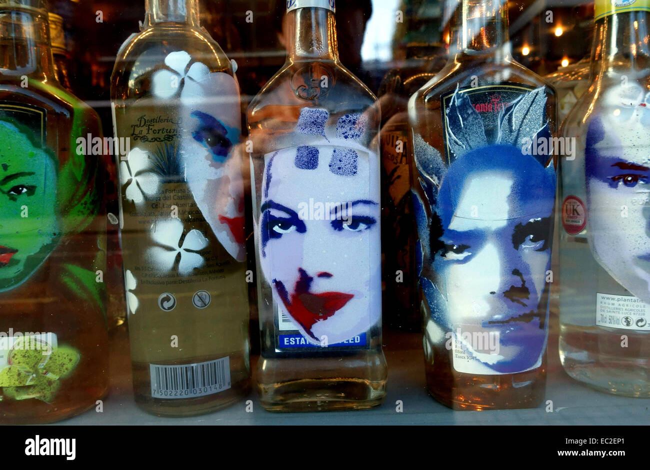 Tequila bottles decorated with portraits in London restaurant window
