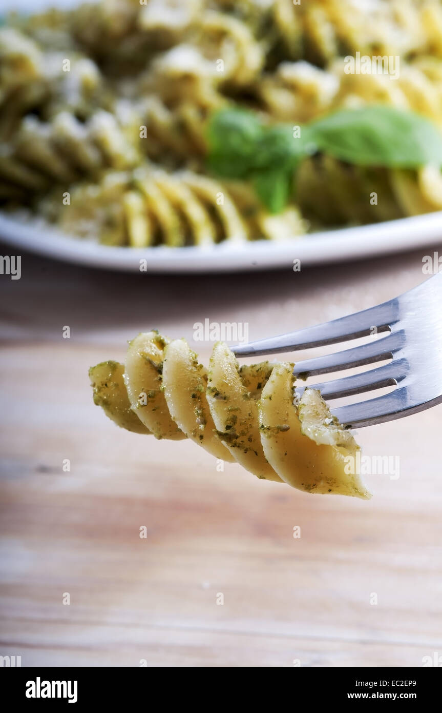 Plate of pasta with pesto Genovese, with fresh basil, olive oil, garlic