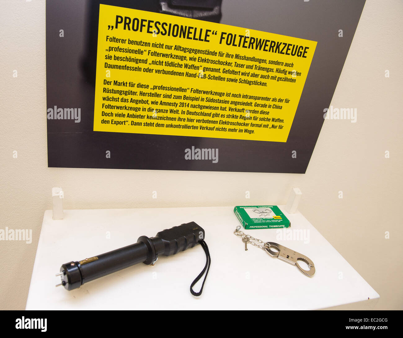 Berlin, Germany. 05th Dec, 2014. A taser (L) and thumbcuffs as professional  torture instruments are seen at the exhibition 'Stop Folter' (lit. Stop  torture) by Amnesty International in Berlin, Germany, 05 December