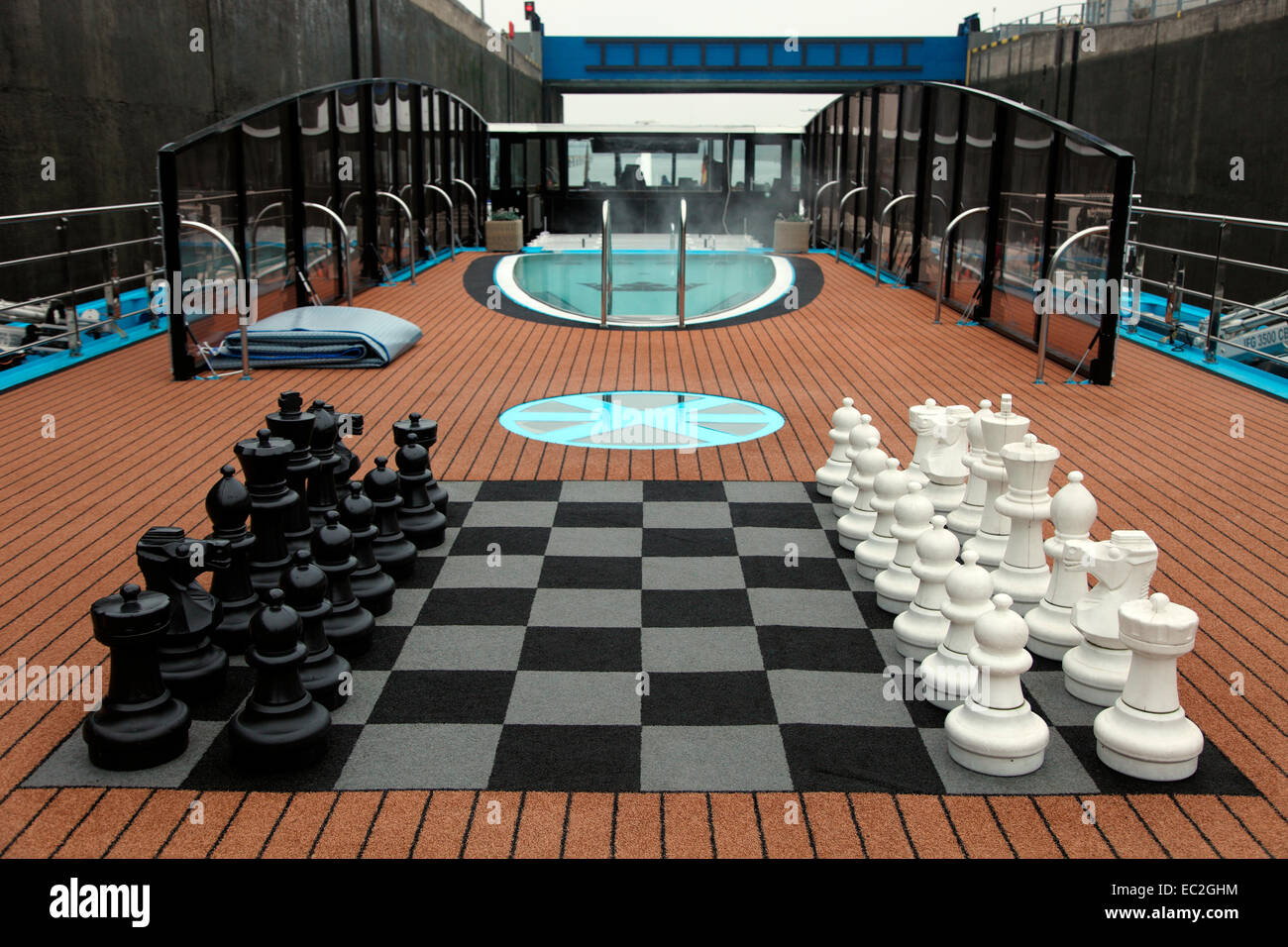 Sun deck of MS Amacerto with chess board and swimmingpool as it goes through a lock on the River Rhine. Stock Photo