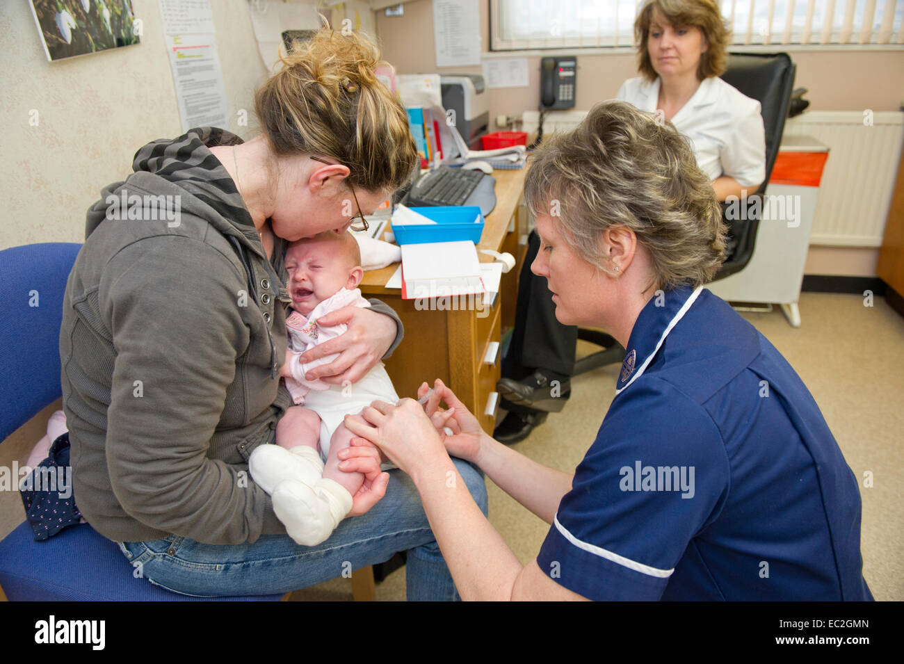 An nurse giving a baby an injection Stock Photo