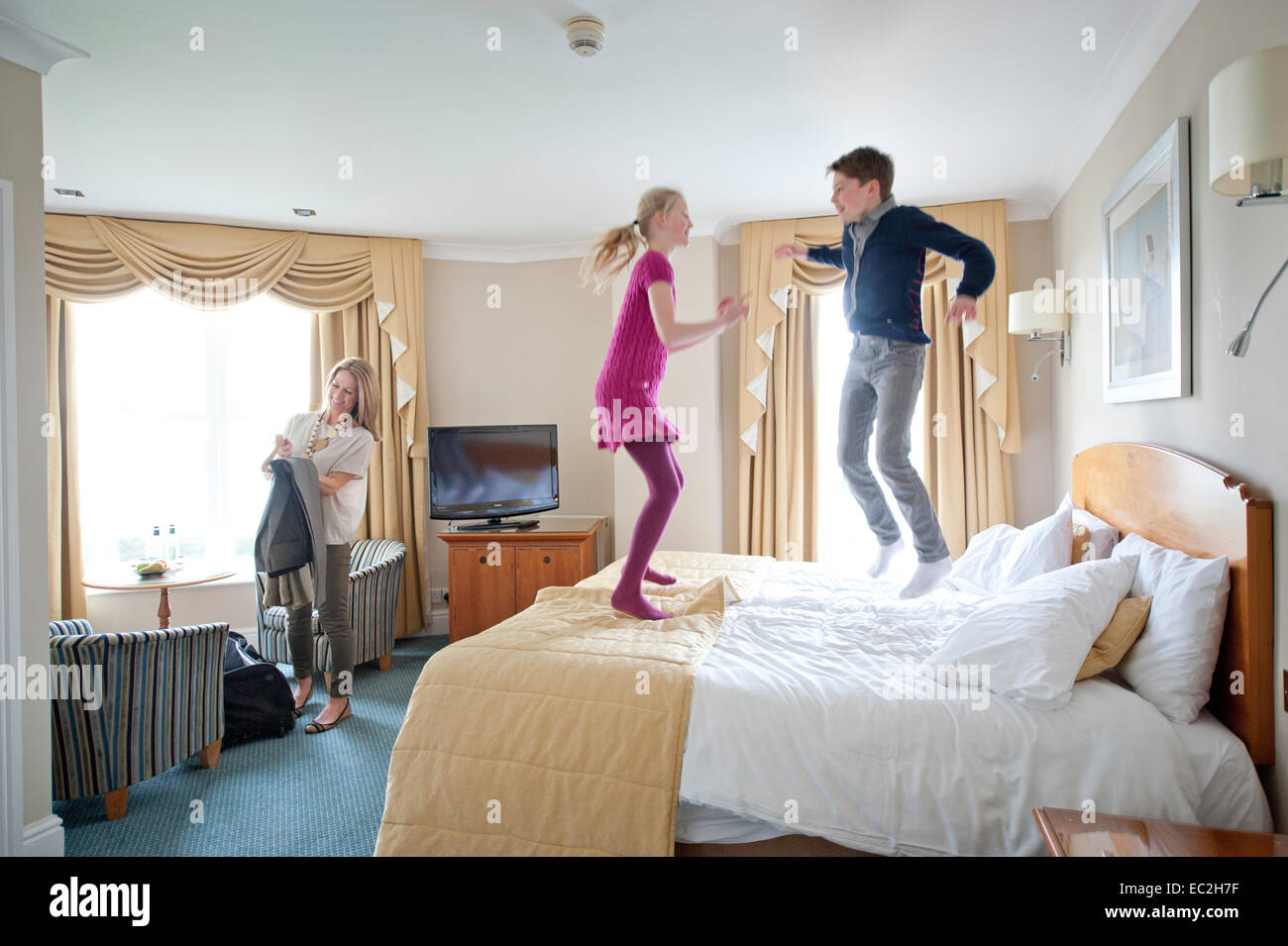A mother and 2 children in a hotel on holiday Stock Photo