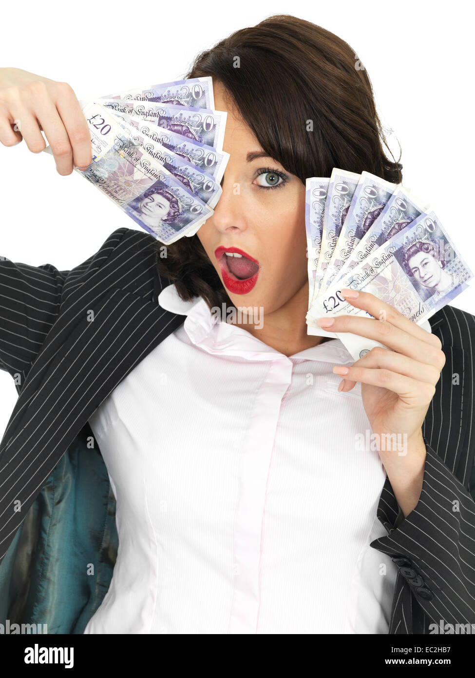 Successful Young Woman Excited Happy And Confident Celebrating Holding A Handful Of Money Isolated Against A White Background With A Clipping Path Stock Photo