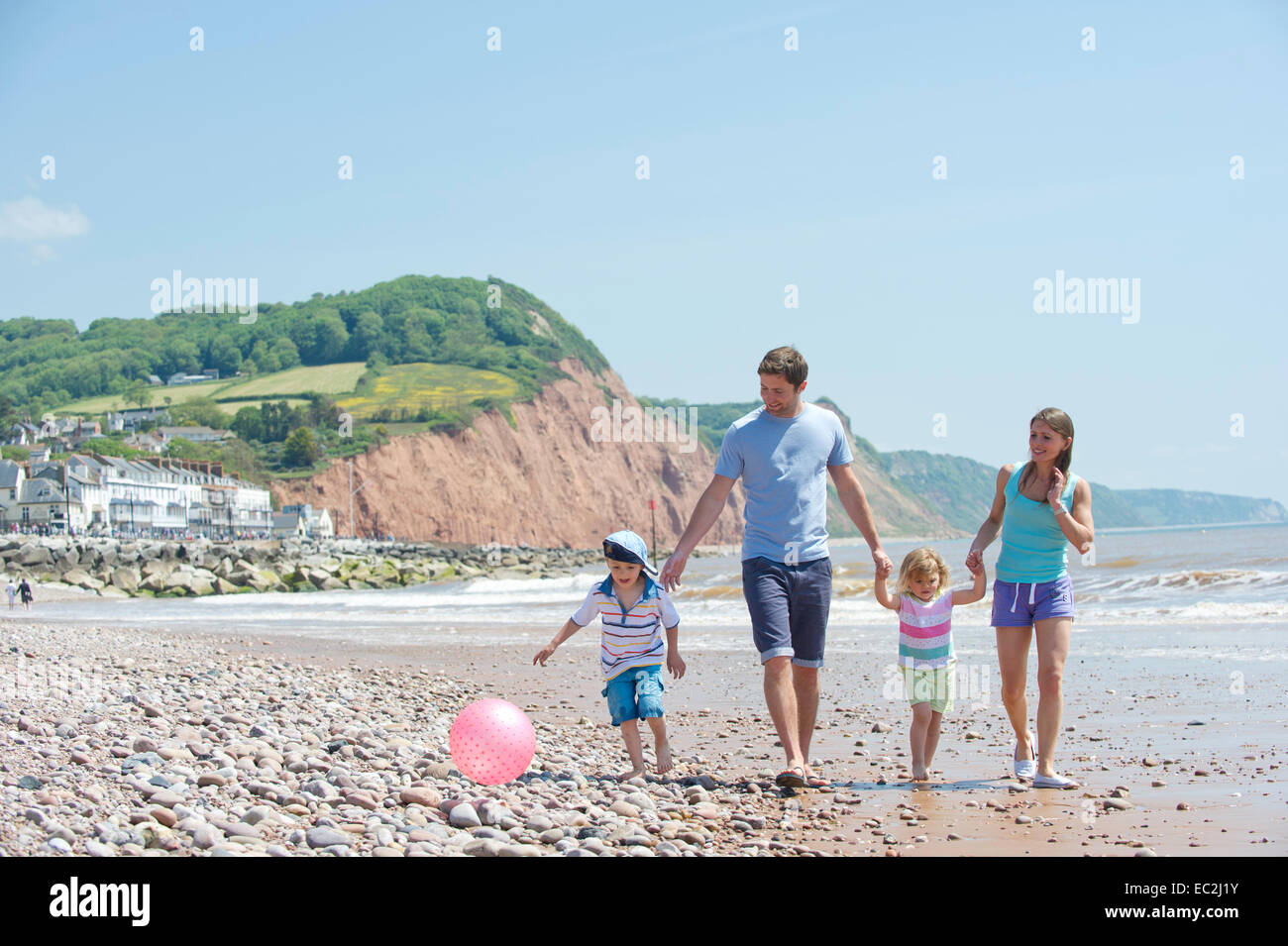 A young family on a beach on the south coast of England Stock Photo