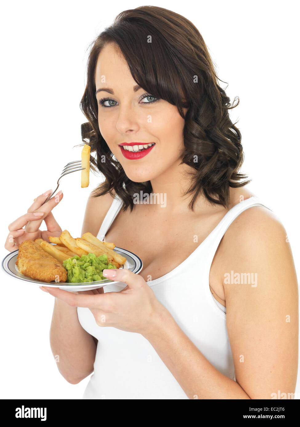 Happy Young Brunette Caucasian Woman Eating Traditional English Fish And Chips Meal With Mushy Peas, Isolated On White With A Clipping Path Alone Stock Photo