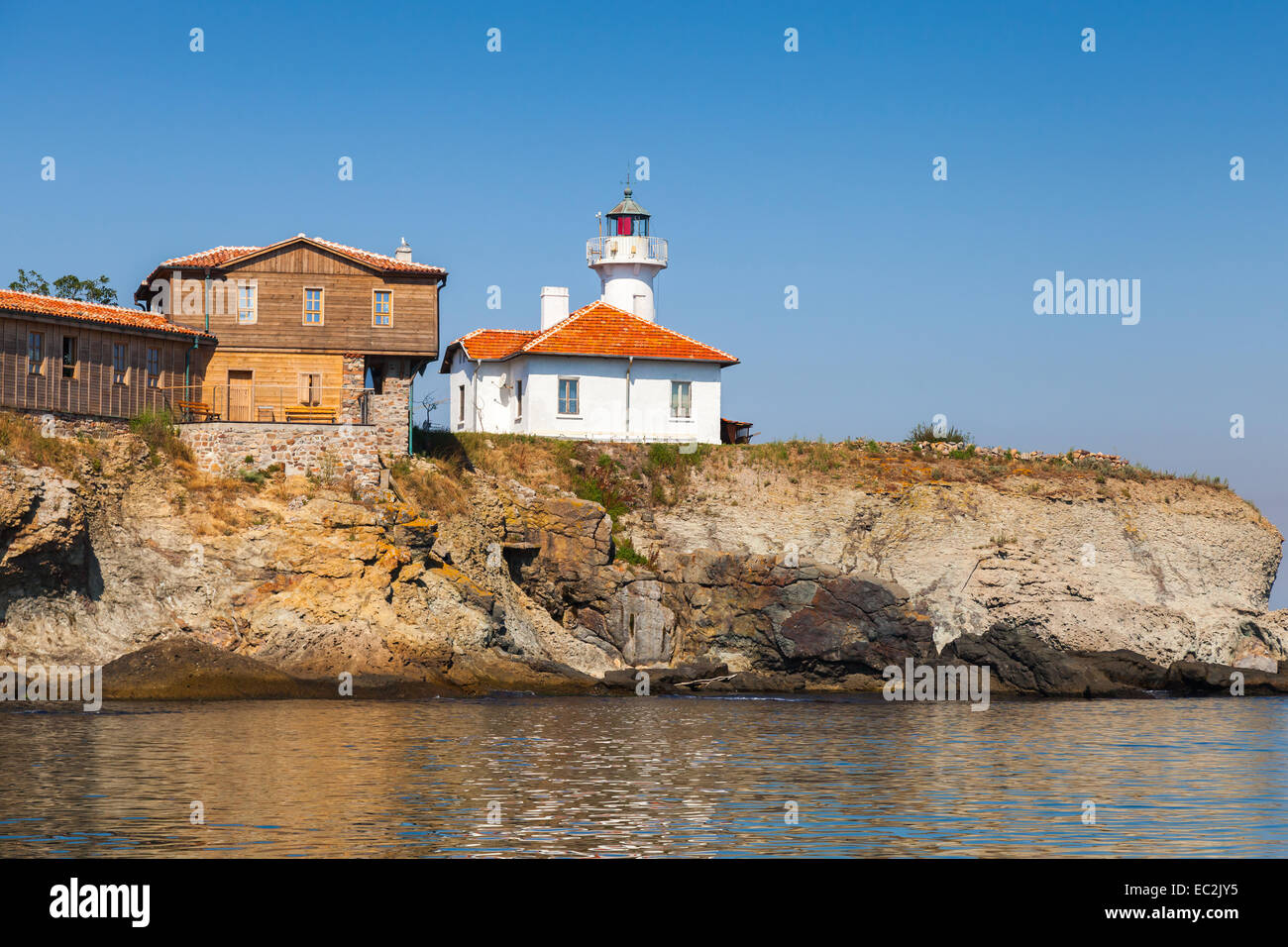 Lighthouse and wooden buildings on St. Anastasia Island. Black Sea, Bulgaria Stock Photo