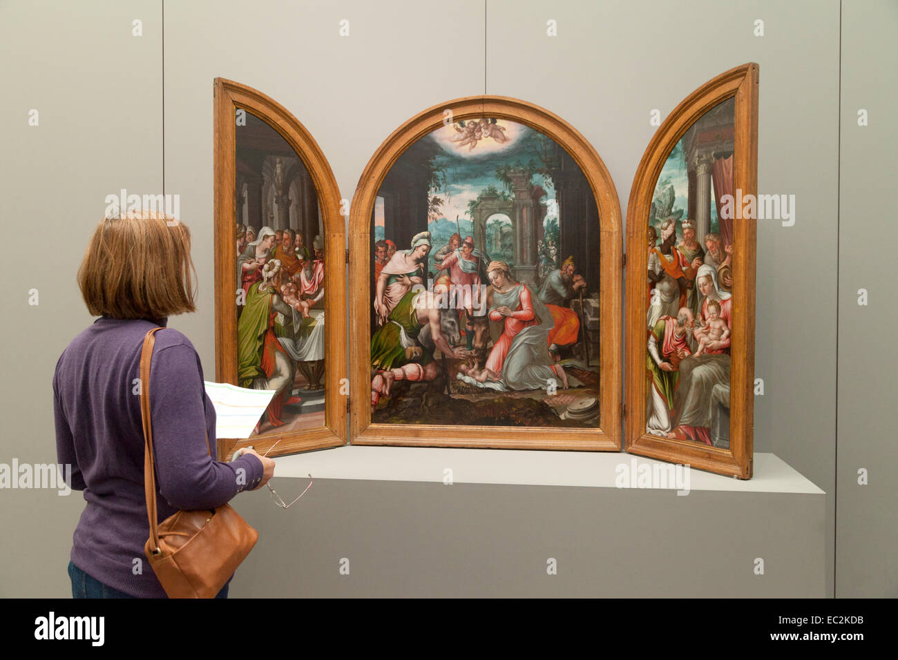 A woman looking at a 16th century Flemish painting by Frans Floris;  the Groeninge Museum, Bruges Belgium, Europe Stock Photo