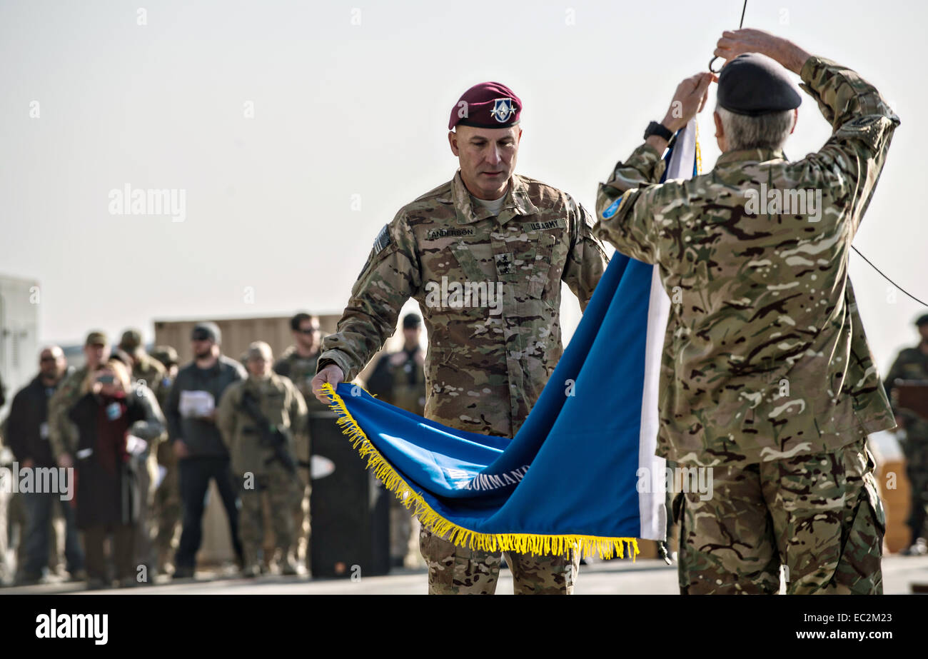 US Army Lt. Gen. Joseph Anderson, Commander, ISAF Joint Command and Royal Army Maj. Gen. Richard Nugee, ISAF Chief of Staff, lower the ISAF Joint Command colors as NATO formally ended combat operations in Afghanistan 13-years after invading to end the Taliban rule during a ceremony December 8, 2014 in Kabul, Afghanistan. Stock Photo