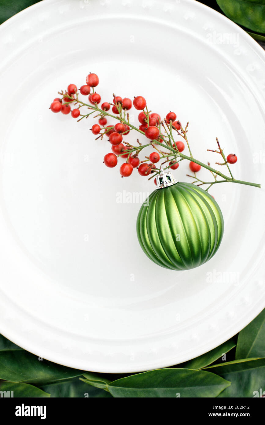 Christmas plate with green ornament and holly Stock Photo