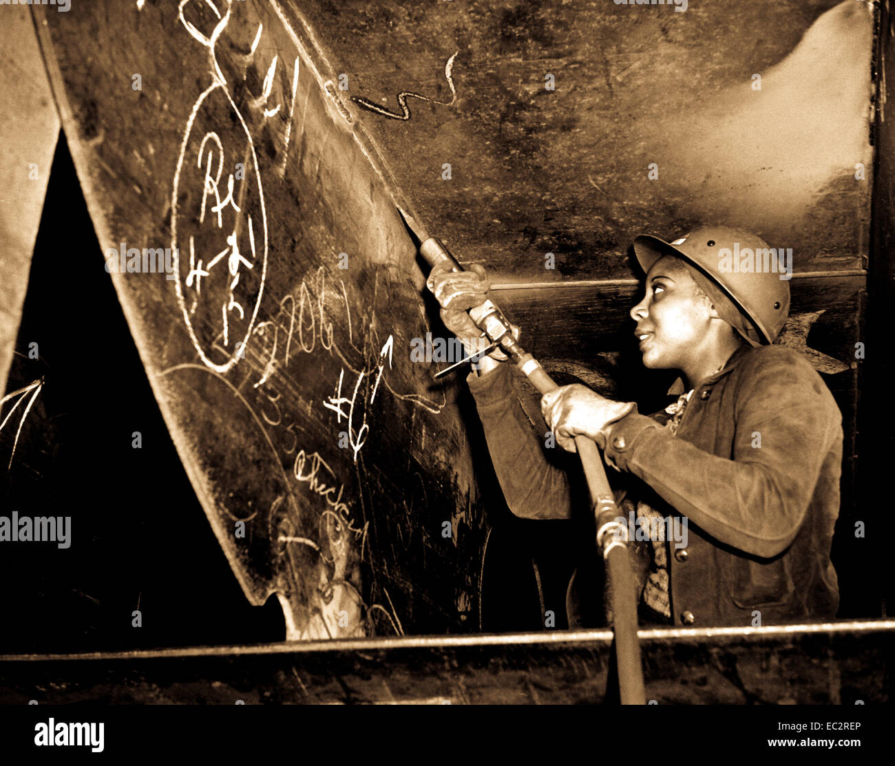 Kaiser shipyards, Richmond, Calif.  Miss  Eastine Cowner, a former waitress, is helping in her job as a scaler to construct the Liberty Ship SS George Washington Carver launched on May 7, 1943.  Photo by E. F. Joseph. Stock Photo