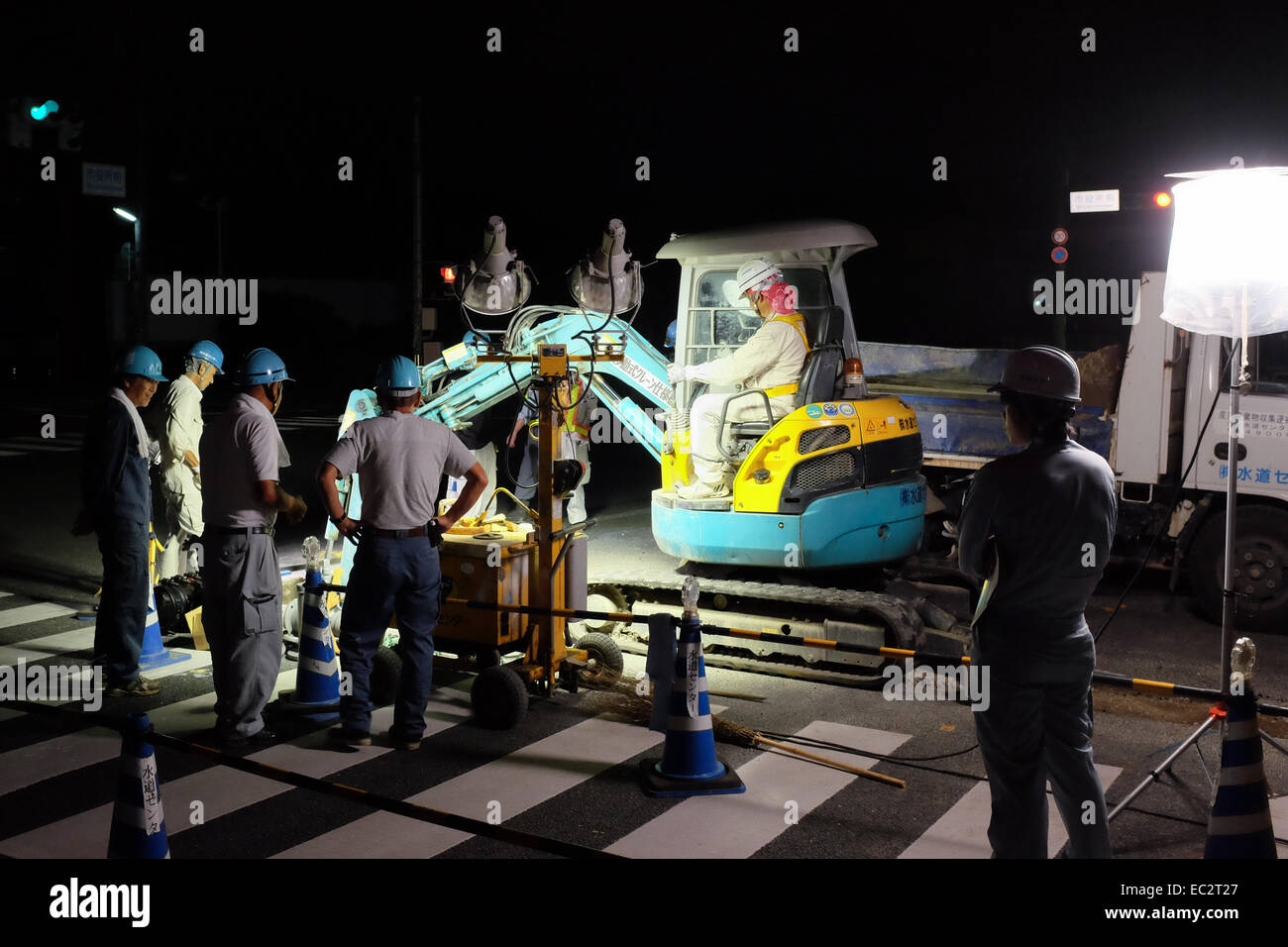 Construction workers in Japan carrying out work at night Stock Photo