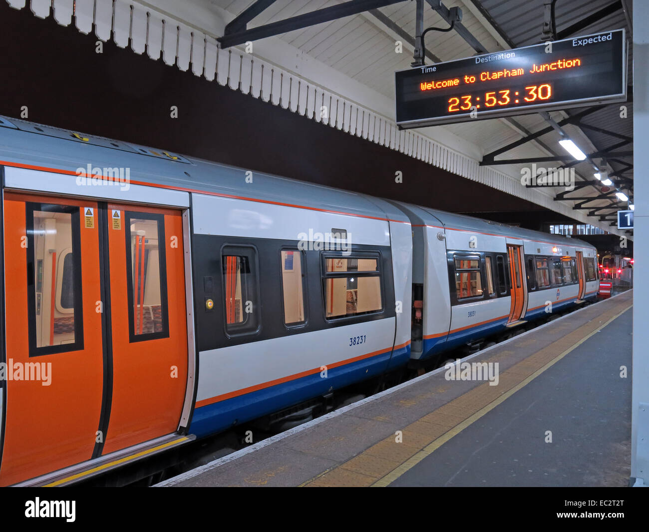 Alone on an Overground platform - Welcome to Clapham Junction railway station, at night, London's busiest, England, UK Stock Photo