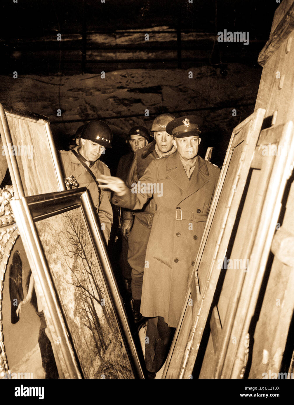 General Dwight D. Eisenhower, Supreme Allied Commander, accompanied by Gen. Omar N. Bradley, and Lt. Gen. George S. Patton, Jr., inspects art treasures stolen by Germans and hildden in salt mine in Germany.  April 12, 1945.  Lt. Moore.  (Army) Stock Photo