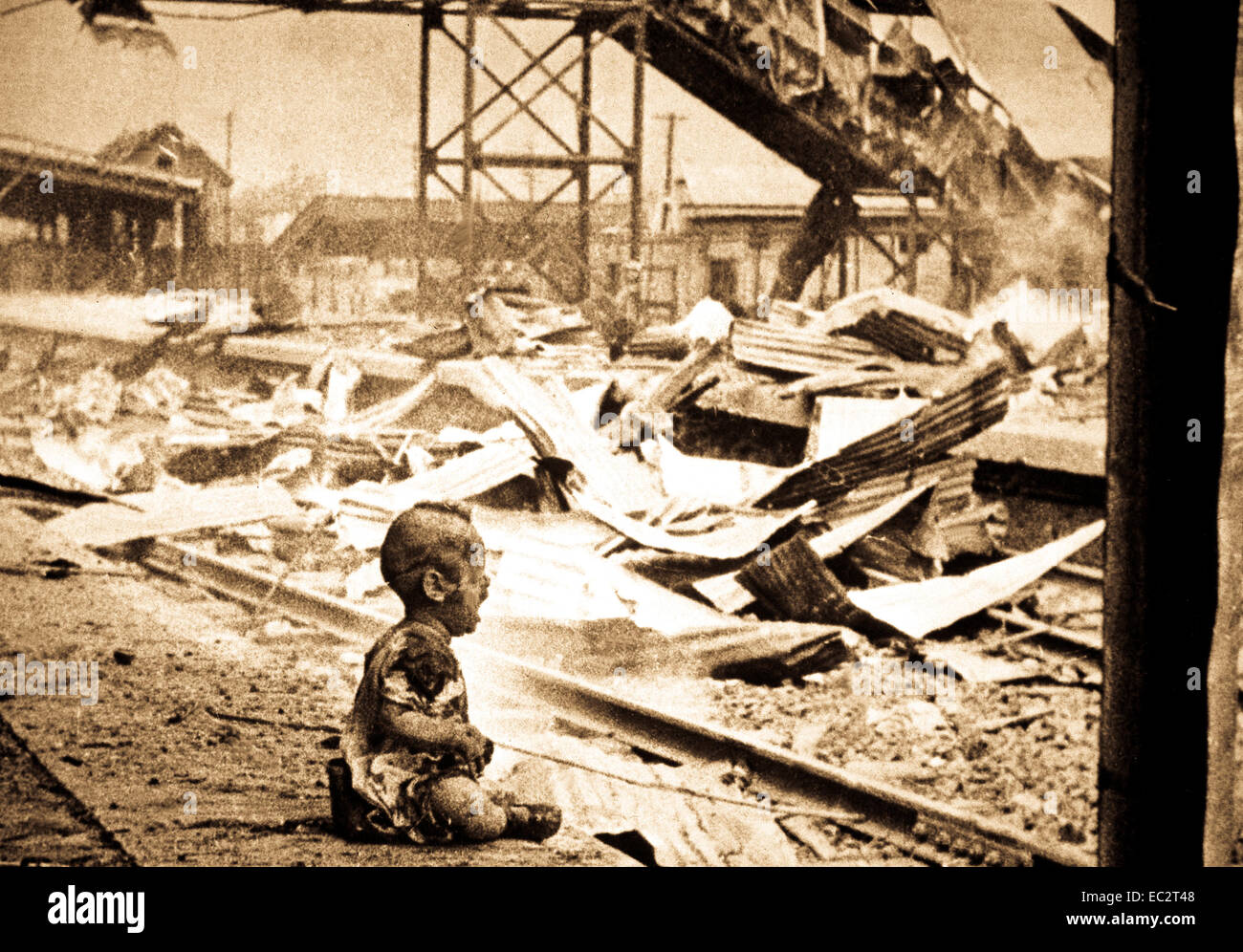 This terrified baby was almost the only human being left alive in Shanghai's South Station after brutal Japanese bombing.  China, August 28, 1937.  H.S. Wong. (OWI) Stock Photo