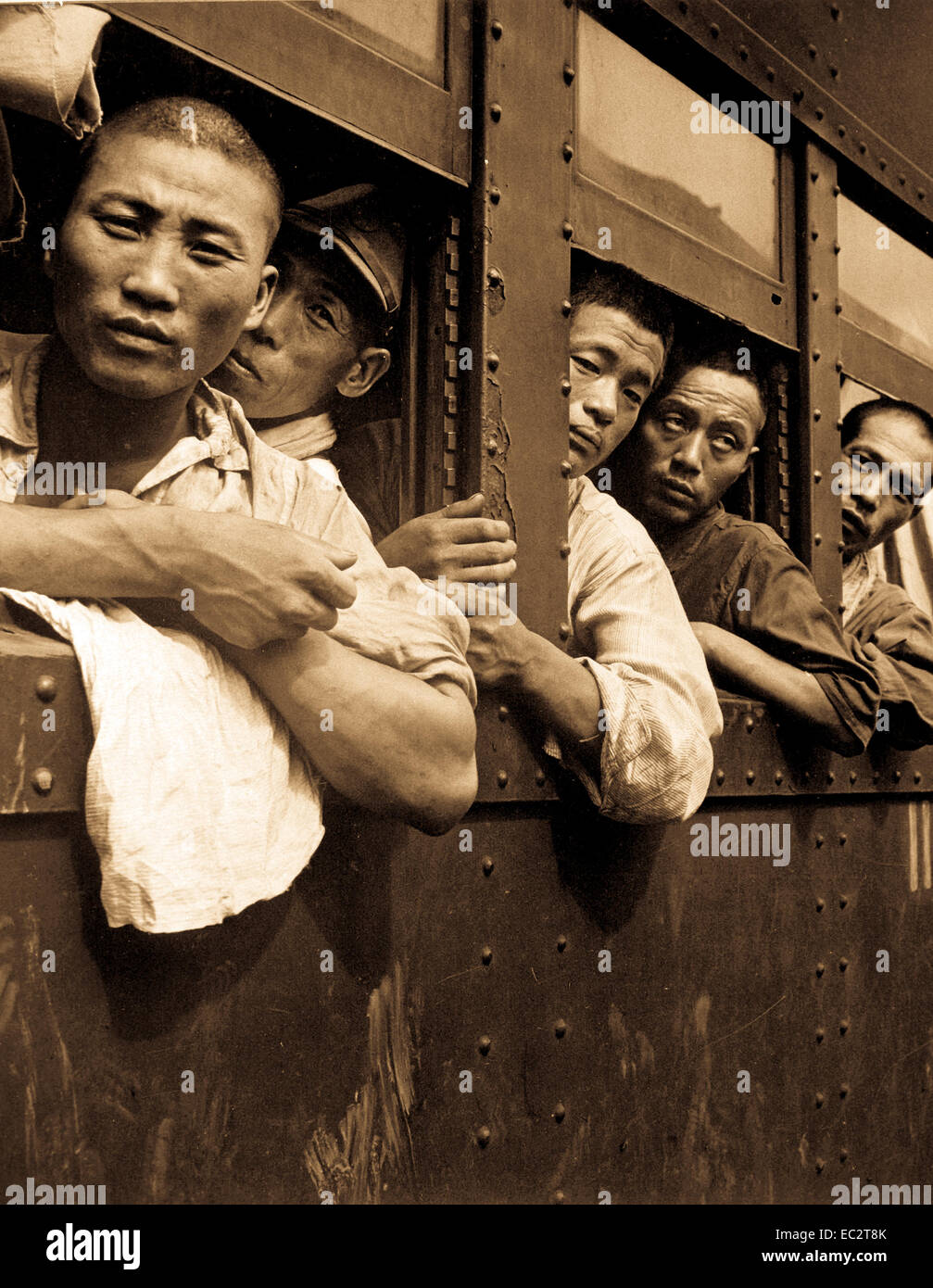 Discharged Japanese soldiers crowd trains as they take advantage of free transportation to their homes after end of World War II in Hiroshima, Japan.  September 1945. Stock Photo