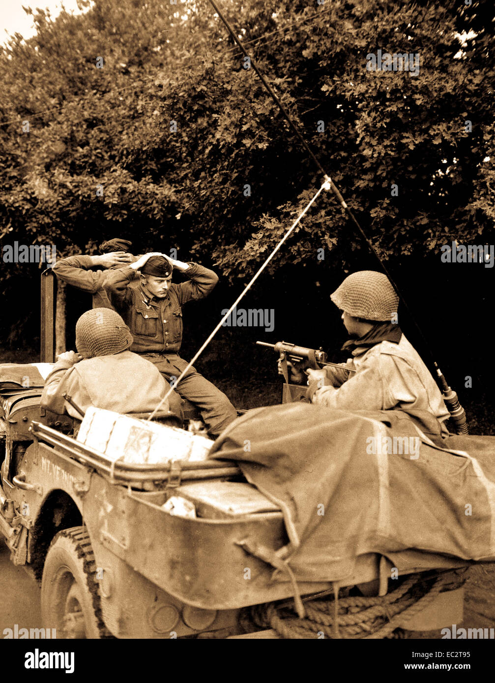 Two German prisoners of war are being taken to the 6th Div. POW Encampment for interrogation and searching. There was 218 captured by the Free French Infantry and 6th Armored Div. troops. Plouay, France. August 28, 1944. Stock Photo