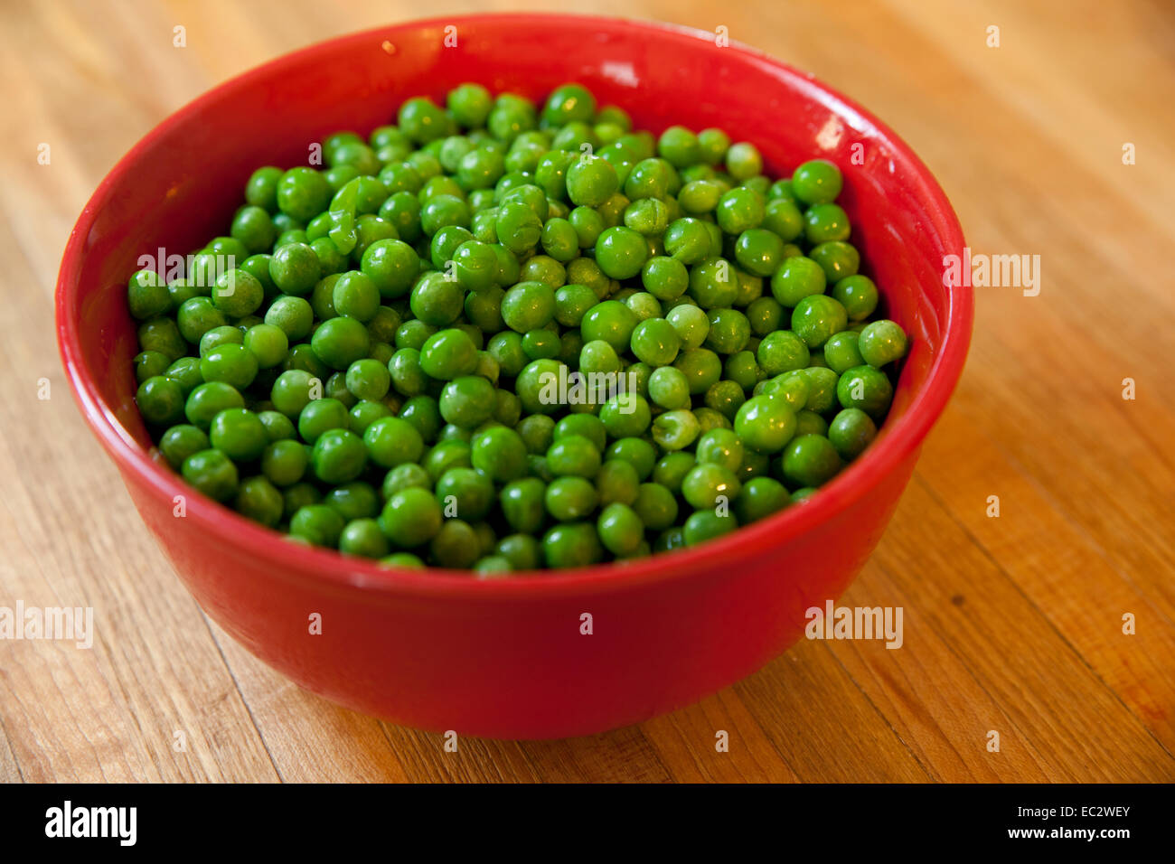 Bowl full of fresh green peas. Stock Photo