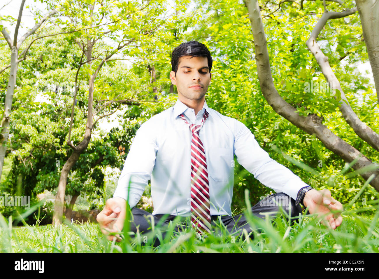 indian Business Man park yoga Meditation Stock Photo