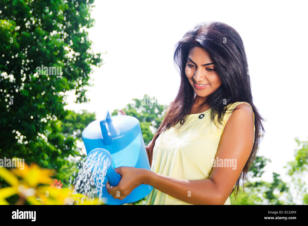 Indian women watering plants hires stock photography and images Alamy