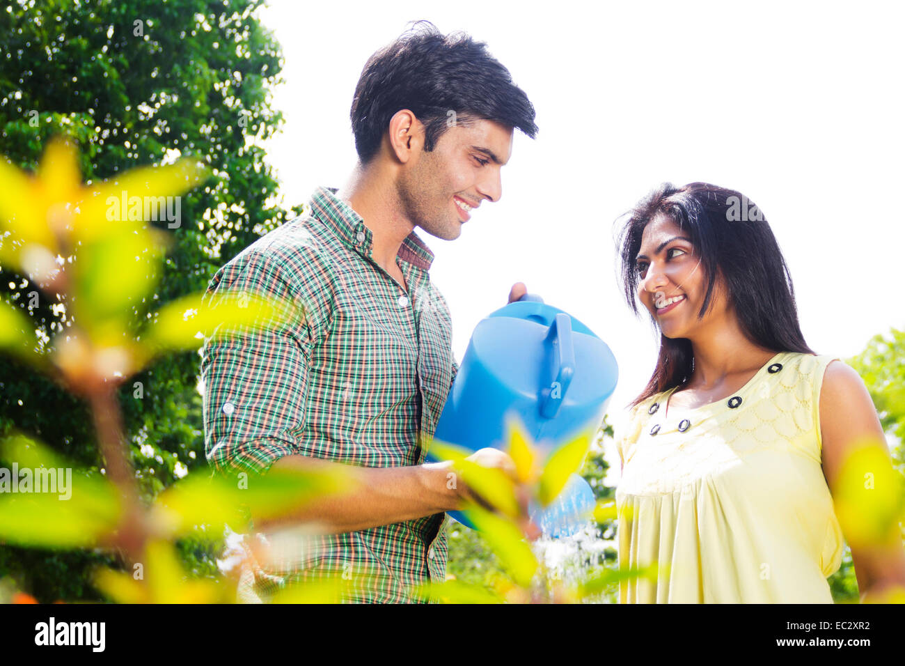 2 indian couple garden Flower Pouring water Stock Photo