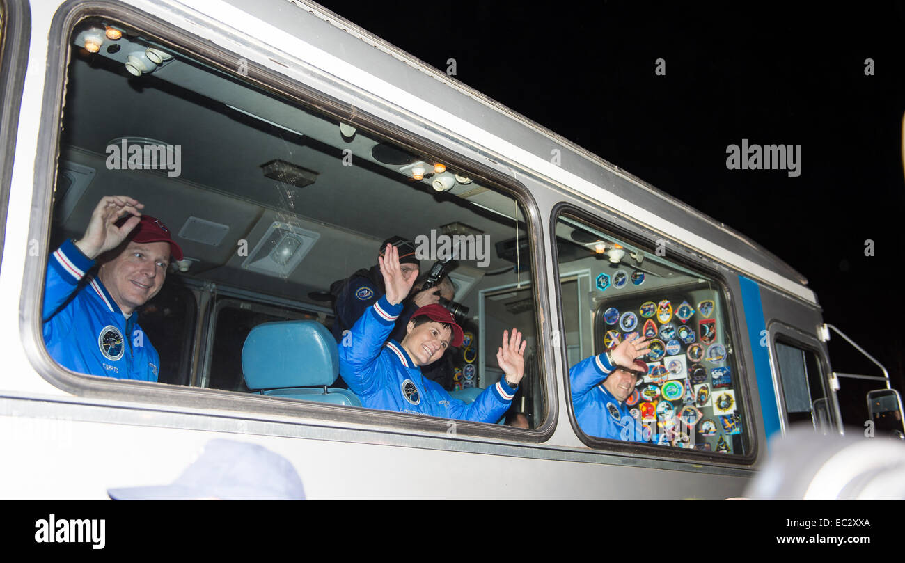 Expedition 42 crew members, Flight Engineer Terry Virts of NASA, left, Flight Engineer Samantha Cristoforetti of the European Space Agency (ESA), center, and Soyuz Commander Anton Shkaplerov of the Russian Federal Space Agency (Roscosmos), right, wave farewell to family and friends as they depart the Cosmonaut Hotel to suit-up for their Soyuz launch to the International Space Station on Sunday, Nov. 23, 2014, in Baikonur, Kazakhstan. Launch of the Soyuz rocket is scheduled for the early hours of Nov. 24 and will send Virts, Cristoforetti, and Shkaplerov on a five and a half month mission aboar Stock Photo