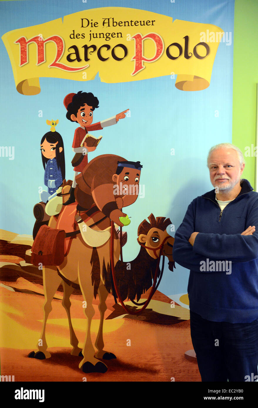Producer and manager of the animation film company MotionWorks, Tony  Loeser, stands in front of a poster for the first season of the children's  ahow 'Die Abenteuer des jungen Marco Polo' (lit.