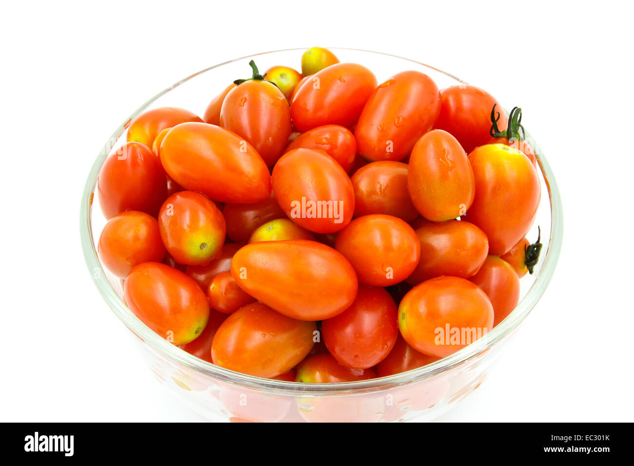 Cherry tomatoes in a glass bowl on white background Stock Photo - Alamy
