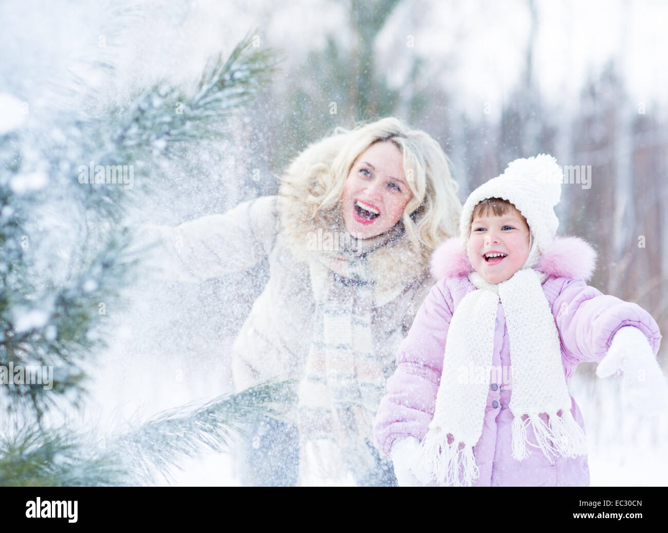 Happy mopther and kid playing with snow in winter outdoor Stock Photo