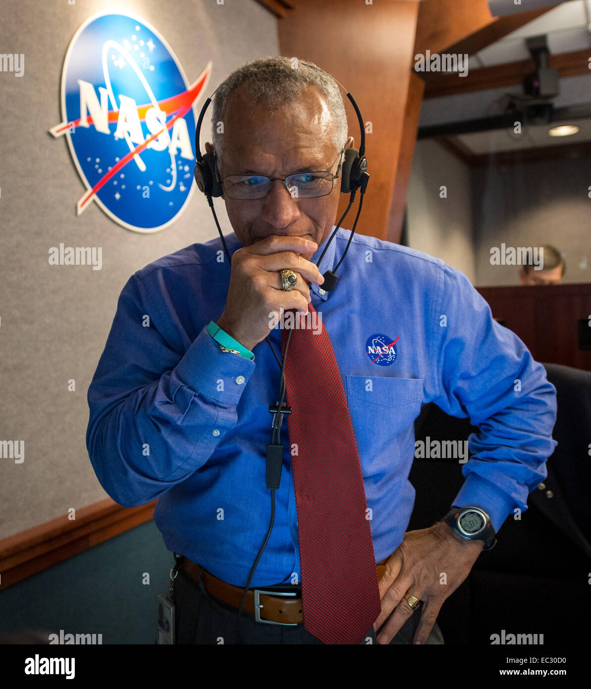 NASA Administrator Charles Bolden pauses for a moment in Building AE at Cape Canaveral Air Force Station after having watched and celebrated the Orion spacecraft splash down in the Pacific Ocean more than three hours after the spacecraft launched onboard a United Launch Alliance Delta IV Heavy rocket from Launch Complex 37, Friday, Dec. 5, 2014, Cape Canaveral, Florida. The Orion spacecraft orbited Earth twice, reaching an altitude of approximately 3,600 miles above Earth before landing. No one was aboard Orion for this flight test, but the spacecraft is designed to allow us to journey to dest Stock Photo