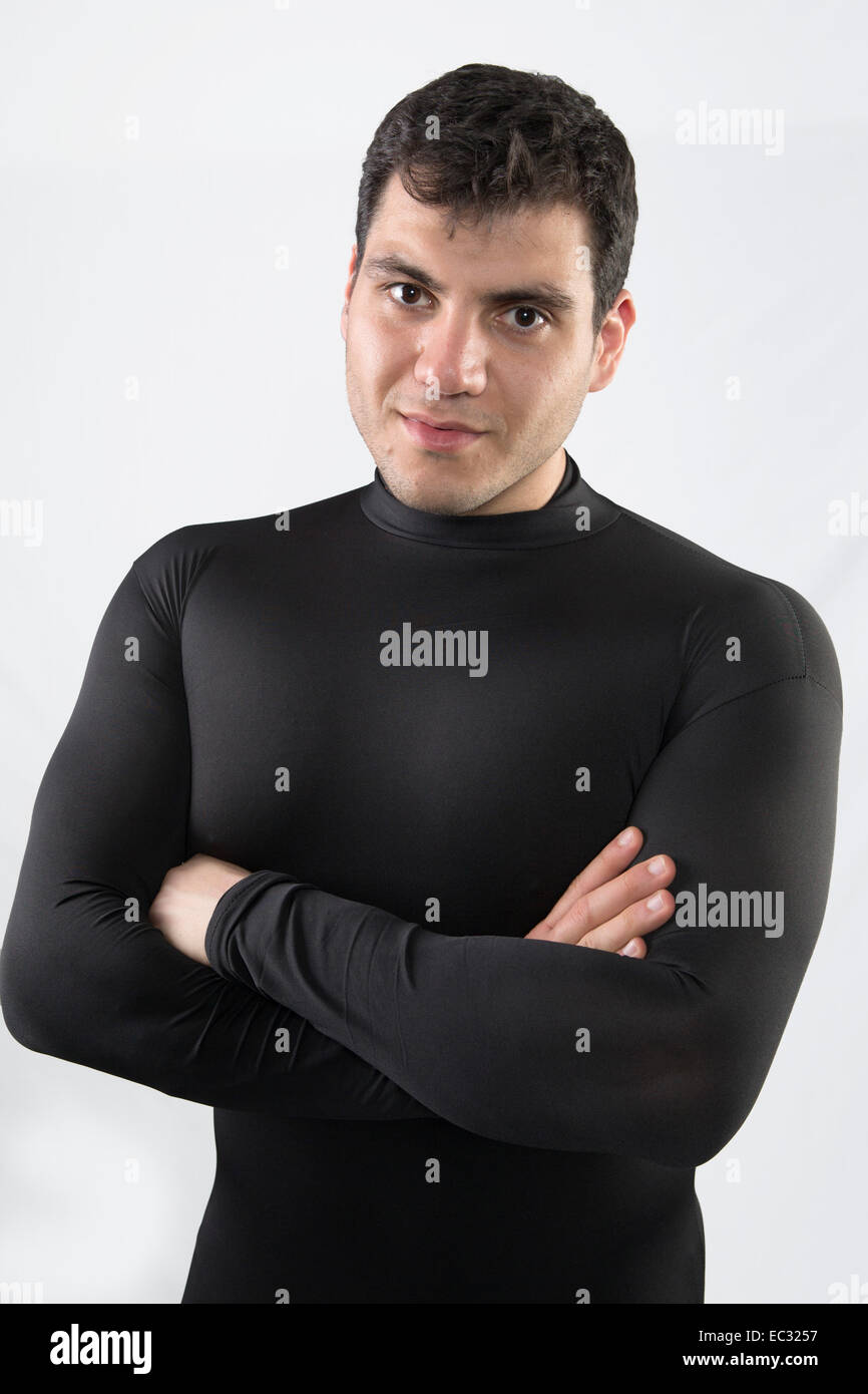 young male with black hair wearing tight fitting black body suit Stock Photo