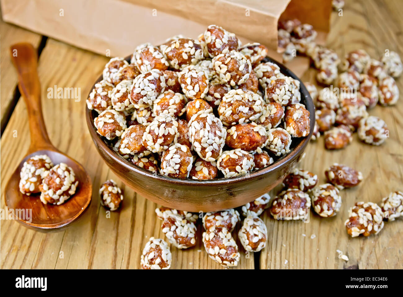 Peanuts in caramel with sesame on board Stock Photo Alamy