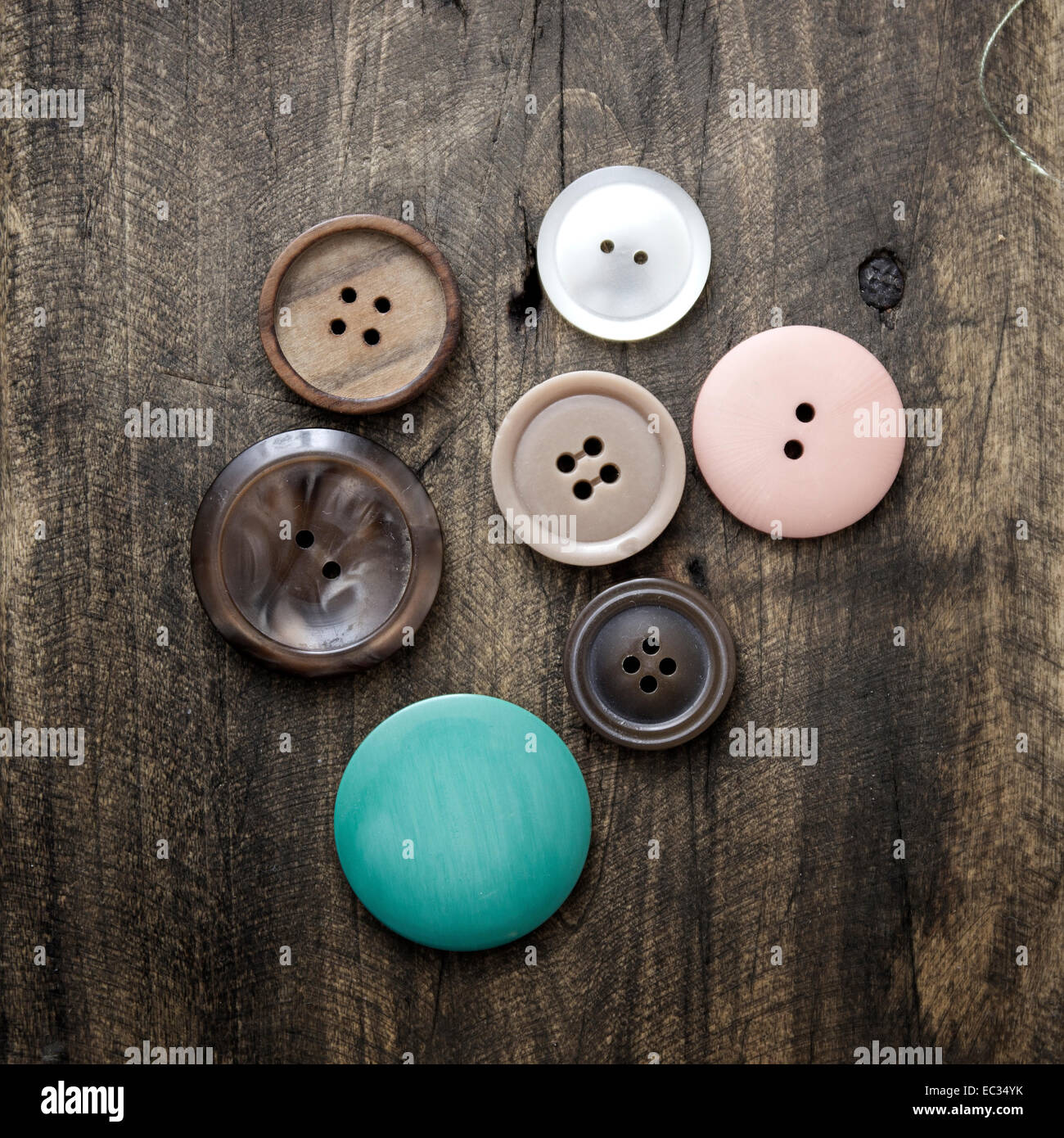 Collection of various buttons on old wooden table Stock Photo - Alamy