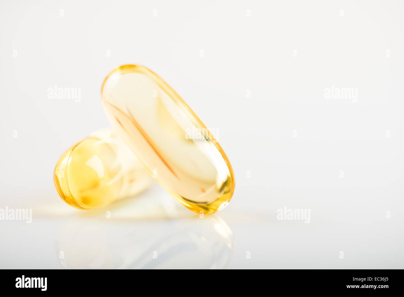 shiny yellow vitamin e fish oil capsule on white background Stock Photo Alamy