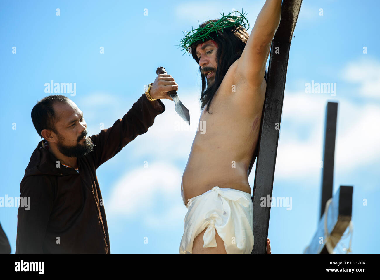 Human Crucifixion - Gilbert Bargayo is nailed to a cross on Good Friday Stock Photo