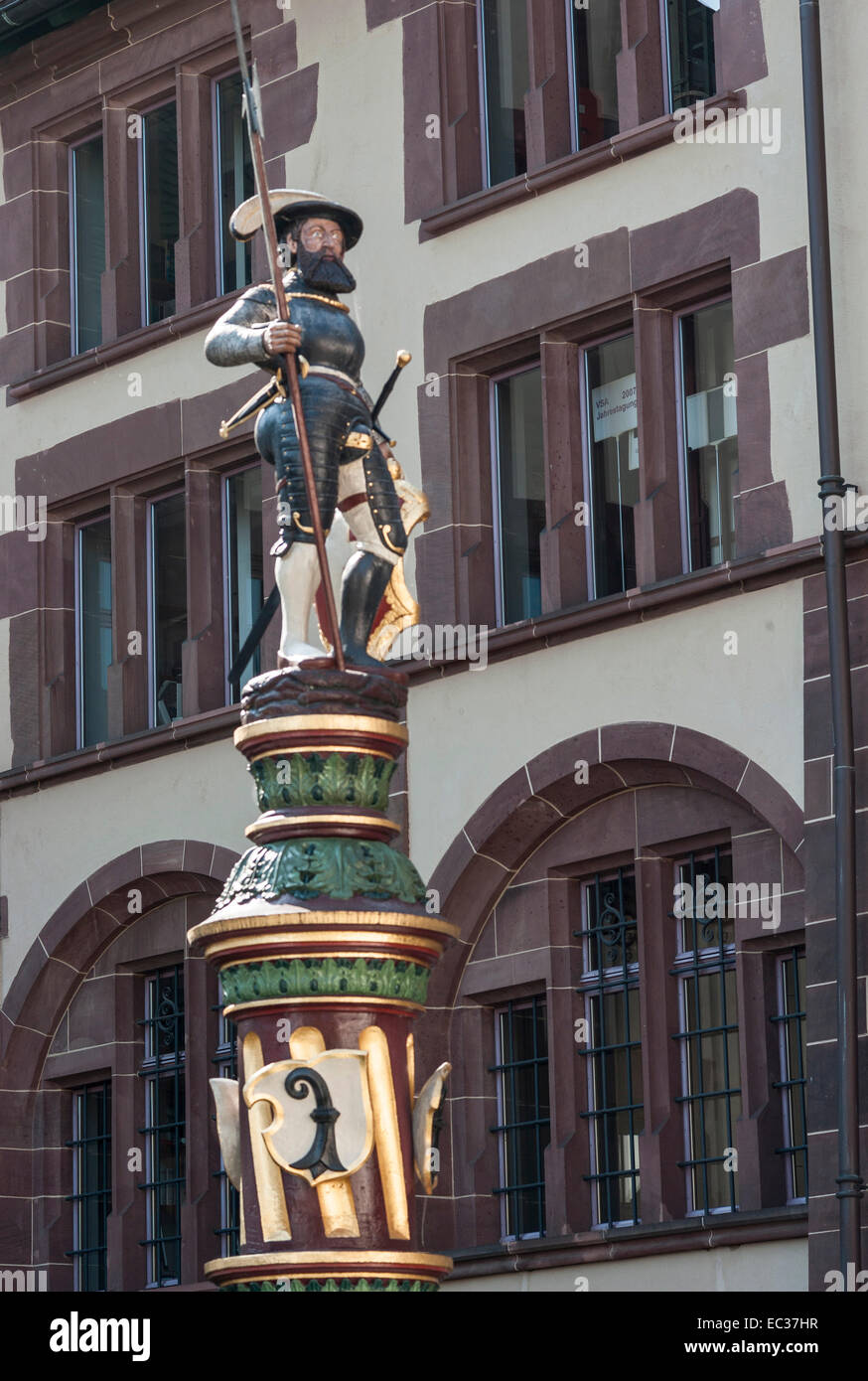 Switzerland, Basel, Statue of a Renaissance era soldier on a pedestal with Bishop the symbol of Basel at the bottom. Stock Photo