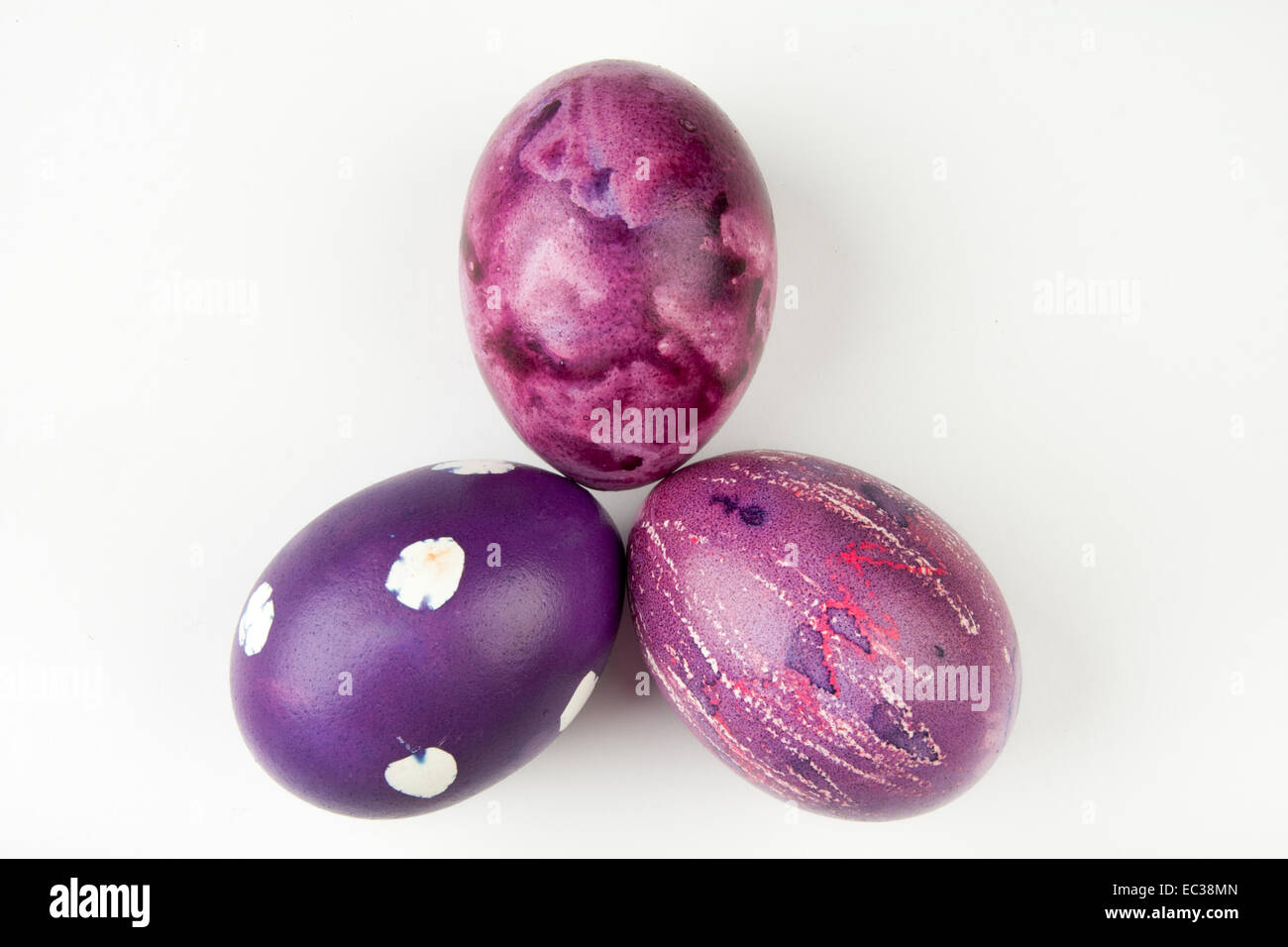 Three Easter eggs in violet colors. Stock Photo