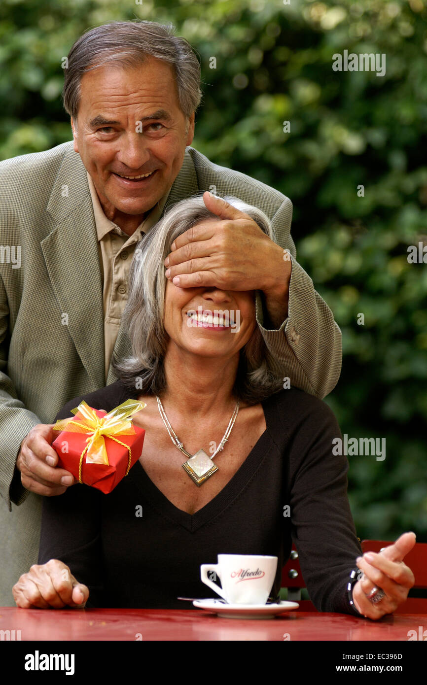 older man gives his wife a present Stock Photo Alamy