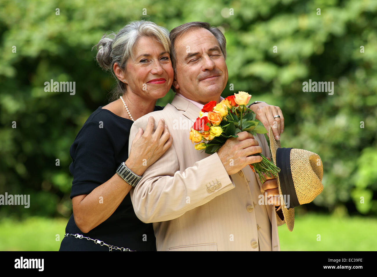 Happy old lady hugging man hi-res stock photography and images - Alamy